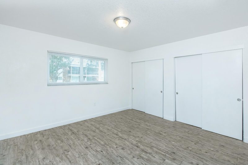 Spacious bedroom with a large window and closet
