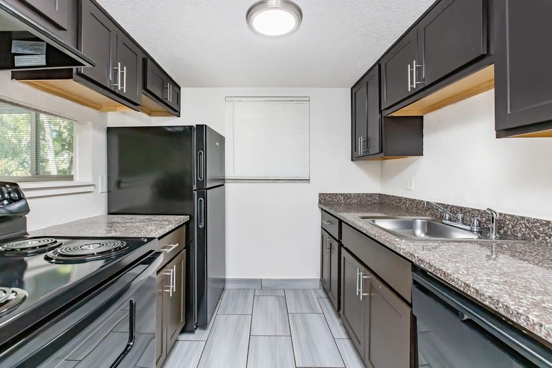Kitchen with granite counters, range and dishwasher